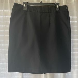 Black skirt with back slit and belt loops.